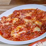 The breakfast table: shakshuka, foul, hummus, manakish and fruit