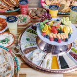 The breakfast table: shakshuka, foul, hummus, manakish and fruit