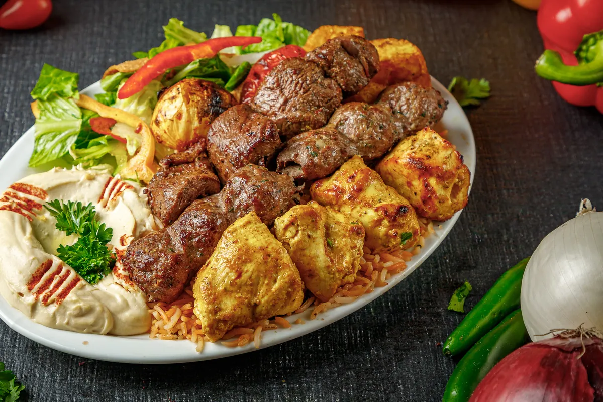 Kebab and shish tawouk plate with hummus and salad